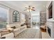 Living room with natural light, ceiling fan, fireplace, built-in shelves, and large rug at 1260 Ashford Creek Ne Way, Atlanta, GA 30319