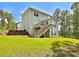 Two story home with a deck, backyard, and stair access at 135 Eastmark Way, Fayetteville, GA 30214