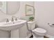 Classic bathroom with a pedestal sink, a modern toilet, and decorative accents at 135 Eastmark Way, Fayetteville, GA 30214