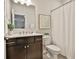 A well lit bathroom with a large vanity, framed art, toilet and shower at 135 Eastmark Way, Fayetteville, GA 30214