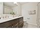 Bathroom featuring a double vanity with modern fixtures and a large mirror at 135 Eastmark Way, Fayetteville, GA 30214
