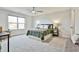 A well-lit bedroom featuring plush carpeting, neutral walls, and ample natural light at 135 Eastmark Way, Fayetteville, GA 30214