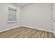 This bedroom features hardwood floors, a window and a closet at 135 Eastmark Way, Fayetteville, GA 30214