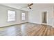 A bright bonus room featuring luxury vinyl plank flooring and two windows for natural light at 135 Eastmark Way, Fayetteville, GA 30214
