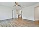 A spacious bonus room featuring luxury vinyl plank flooring and a modern ceiling fan at 135 Eastmark Way, Fayetteville, GA 30214