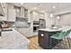 Modern kitchen featuring stainless steel appliances, granite countertops, and a stylish kitchen island with barstool seating at 135 Eastmark Way, Fayetteville, GA 30214