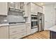 Well-equipped kitchen with stainless steel appliances, sleek cabinets, and efficient layout at 135 Eastmark Way, Fayetteville, GA 30214