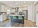 Modern kitchen with stainless steel appliances, kitchen island with seating and pendant lighting at 135 Eastmark Way, Fayetteville, GA 30214