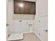 A functional laundry room with overhead cabinets and utility sink at 135 Eastmark Way, Fayetteville, GA 30214
