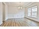 Elegant living room with hardwood floors, tray ceiling, and large windows at 135 Eastmark Way, Fayetteville, GA 30214