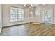 Open-concept living room with wood floors, white trim, and access to other rooms at 135 Eastmark Way, Fayetteville, GA 30214