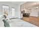 Open-concept living area providing access to an outdoor space and the home's modern kitchen at 135 Eastmark Way, Fayetteville, GA 30214