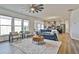Bright living room open to the kitchen, featuring large windows and comfortable seating at 135 Eastmark Way, Fayetteville, GA 30214