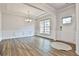 Spacious living room featuring wood floors, white trim, and ample natural light at 135 Eastmark Way, Fayetteville, GA 30214