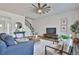 Comfortable living room with staircase, TV, a ceiling fan and ample seating for relaxation at 135 Eastmark Way, Fayetteville, GA 30214