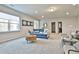 Well-lit living room with recessed lighting, a comfortable blue sofa, and modern decor at 135 Eastmark Way, Fayetteville, GA 30214