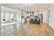 Open living space connecting to a modern kitchen, offering ample natural light and seating at 135 Eastmark Way, Fayetteville, GA 30214