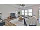 Spacious living room with large windows, modern ceiling fan, and comfortable seating arrangement at 135 Eastmark Way, Fayetteville, GA 30214
