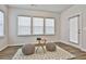 Sun-filled seating area with a view of the outside, seating, and hardwood floors at 135 Eastmark Way, Fayetteville, GA 30214