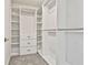 Bright, walk-in closet with custom shelving and drawer units for optimal organization at 135 Eastmark Way, Fayetteville, GA 30214