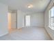 This spacious bedroom is carpeted with neutral walls and baseboards and has two entries at 2761 Dolce Rd, Dacula, GA 30019