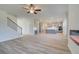 Bright, open-concept living room with light wood floors and a view of the modern kitchen at 2761 Dolce Rd, Dacula, GA 30019