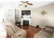 Comfortable living room featuring a fireplace, hardwood floors, and neutral decor at 309 Daffodil Dr, Temple, GA 30179