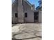 Exterior shot of the backyard with a gray facade and brick chimney, ready for outdoor enjoyment at 4031 Old Fairburn Rd, Atlanta, GA 30349