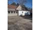Exterior showcasing the tan-sided house with a rear garage and driveway at 4031 Old Fairburn Rd, Atlanta, GA 30349