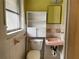 Small bathroom with a pink sink and white tiled walls at 70 Rockmart Nw Dr, Atlanta, GA 30314