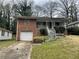 Traditional brick home with a single-car garage and a small front yard at 70 Rockmart Nw Dr, Atlanta, GA 30314