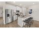 Eat-in kitchen boasts stainless appliances, island with seating, and bright white cabinets at 1330 Magnolia Bend Way # 306, Jonesboro, GA 30238