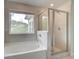 Bathroom featuring bathtub, separate shower, and a large window at 250 Arnewood Cir, Mcdonough, GA 30253