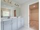 Bathroom featuring double vanity and walk-in closet at 250 Arnewood Cir, Mcdonough, GA 30253