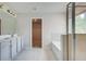 Bathroom featuring double vanity, bathtub, and shower with glass door at 250 Arnewood Cir, Mcdonough, GA 30253
