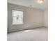 Bright bedroom featuring one window, neutral walls, and carpet at 250 Arnewood Cir, Mcdonough, GA 30253