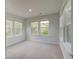 Bedroom with three large windows, and neutral decor and carpet at 250 Arnewood Cir, Mcdonough, GA 30253