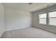Neutral bedroom featuring two windows, neutral walls, and carpet at 250 Arnewood Cir, Mcdonough, GA 30253
