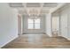 Elegant dining area features hardwood floors, coffered ceilings, and a modern chandelier for sophisticated dining at 250 Arnewood Cir, Mcdonough, GA 30253