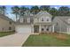 Charming two-story home features a welcoming front porch, attached garage, and professionally landscaped yard at 250 Arnewood Cir, Mcdonough, GA 30253
