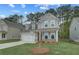 Attractive two-story home showcasing a well-maintained lawn, attached garage, and inviting front porch at 250 Arnewood Cir, Mcdonough, GA 30253