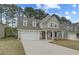Beautiful home with a well-kept lawn, attached two-car garage, and cozy covered porch entrance at 250 Arnewood Cir, Mcdonough, GA 30253