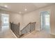Hallway with natural light featuring wooden banisters and neutral color carpets at 250 Arnewood Cir, Mcdonough, GA 30253