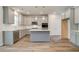Bright kitchen featuring an island, stainless steel appliances, and gray cabinets with modern light fixtures at 250 Arnewood Cir, Mcdonough, GA 30253