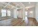 Open-concept living space with hardwood floors, neutral walls, and access to the kitchen and dining areas at 250 Arnewood Cir, Mcdonough, GA 30253