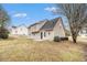 Backyard featuring a concrete patio, grass, partial fence and mature trees at 2549 Greenville Way, Decatur, GA 30034