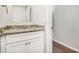 Half bathroom featuring hardwood floors, granite countertop and white cabinets at 2549 Greenville Way, Decatur, GA 30034