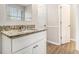 Bathroom featuring a granite countertop, vanity, mirror, and a bright window at 2549 Greenville Way, Decatur, GA 30034