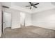 Spacious bedroom featuring a tray ceiling with fan, neutral walls and carpet at 2549 Greenville Way, Decatur, GA 30034