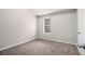 Cozy bedroom featuring neutral walls, plush carpet, and a bright window at 2549 Greenville Way, Decatur, GA 30034